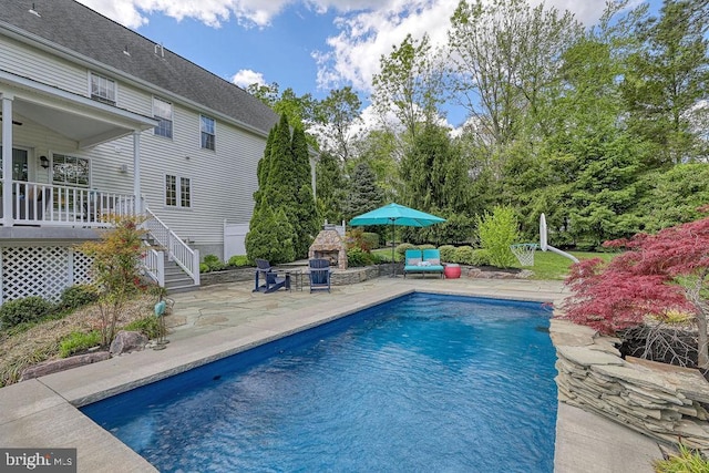 outdoor pool featuring stairs and a patio area