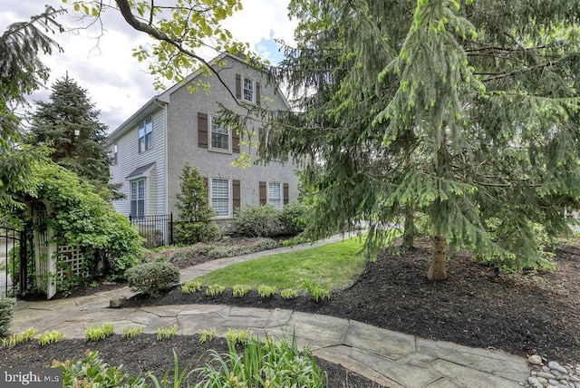 view of front of property with fence and stucco siding