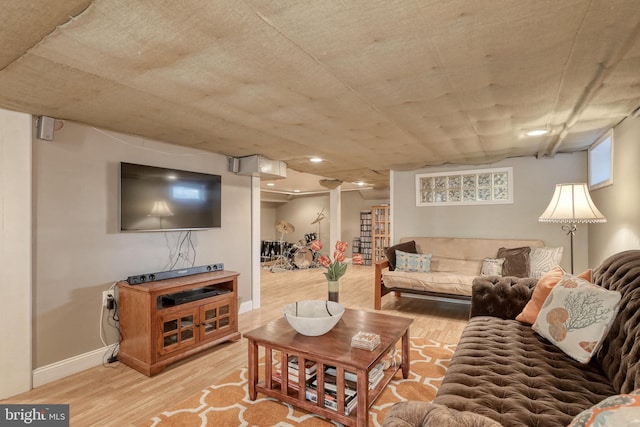 living area featuring baseboards and light wood-type flooring