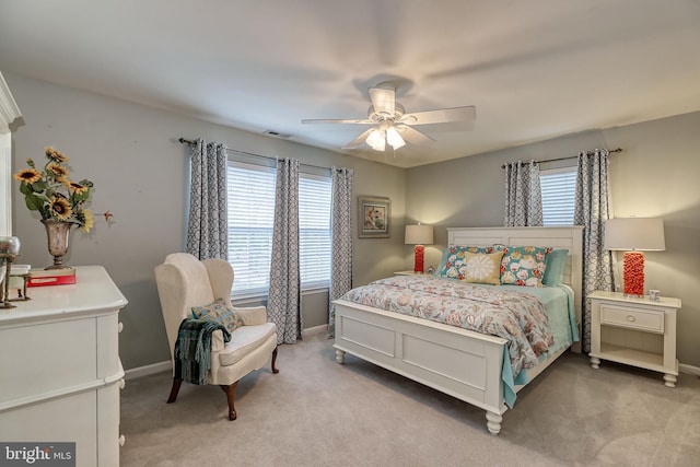 bedroom featuring light carpet, visible vents, ceiling fan, and baseboards