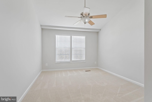 spare room with visible vents, baseboards, carpet floors, and ceiling fan