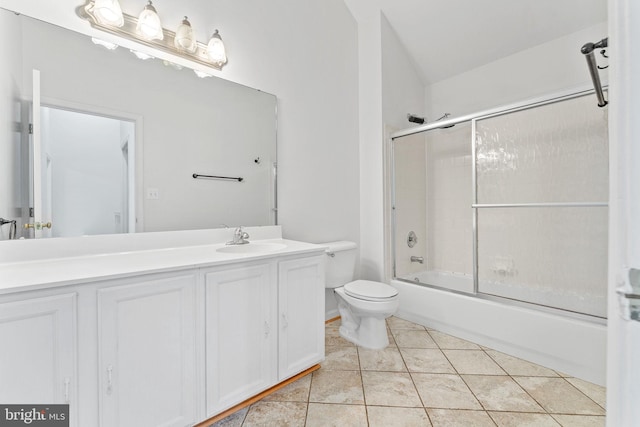 full bath featuring tile patterned floors, combined bath / shower with glass door, toilet, and vanity