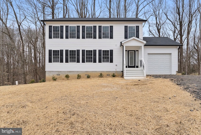 colonial-style house featuring a garage and crawl space