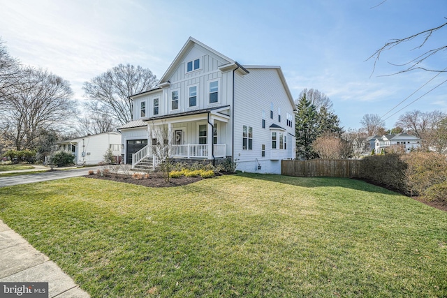 view of front facade with aphalt driveway, a porch, fence, board and batten siding, and a front yard