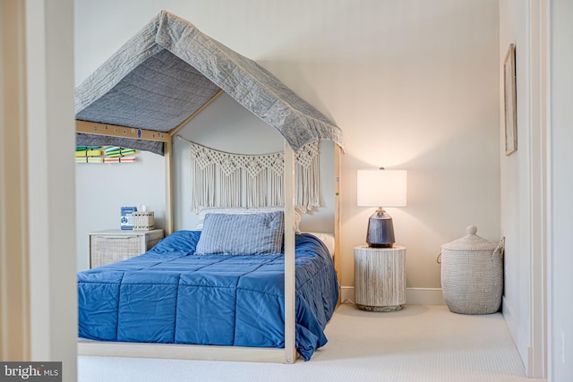 bedroom featuring carpet flooring and baseboards