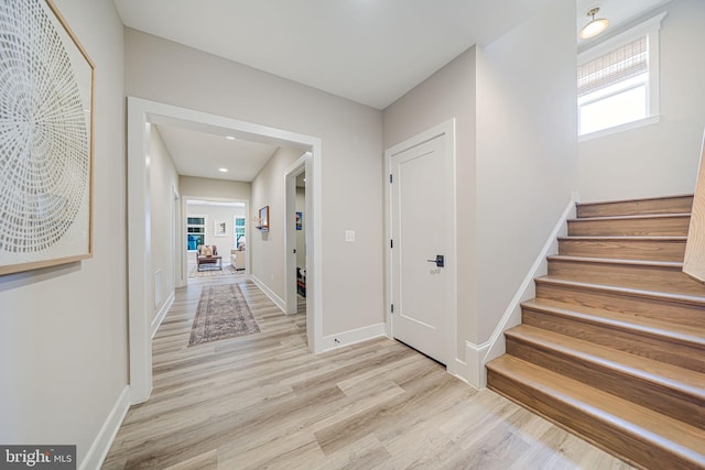 interior space with visible vents, stairs, baseboards, and wood finished floors