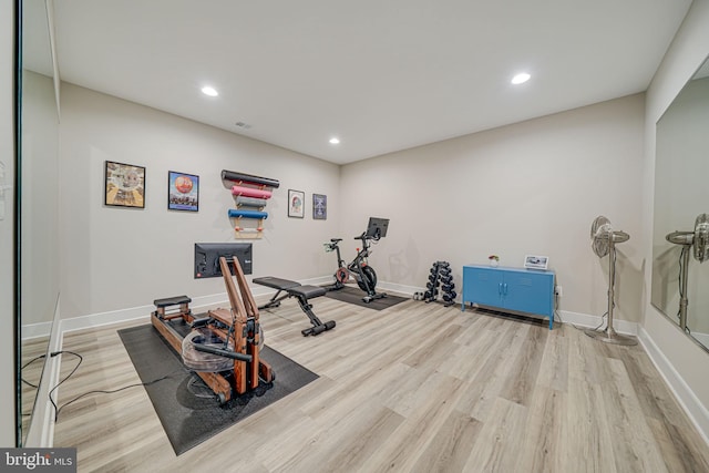 exercise area with recessed lighting, baseboards, and light wood-style floors