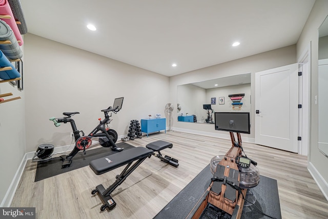 exercise area featuring recessed lighting, baseboards, and light wood finished floors