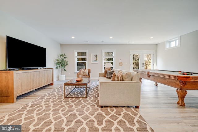 living room featuring recessed lighting, light wood-style flooring, and baseboards