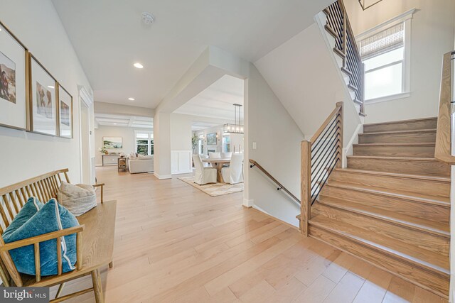 entryway featuring stairway, recessed lighting, light wood-type flooring, and a chandelier