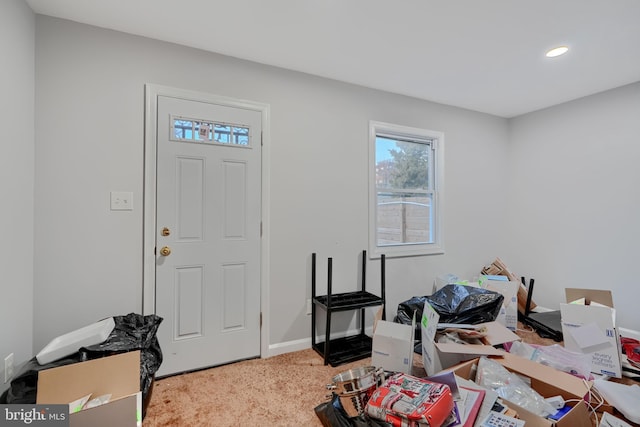 carpeted entryway with recessed lighting and baseboards