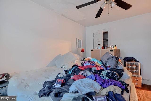 bedroom with a ceiling fan and wood finished floors