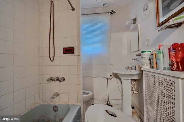 bathroom featuring tub / shower combination and toilet