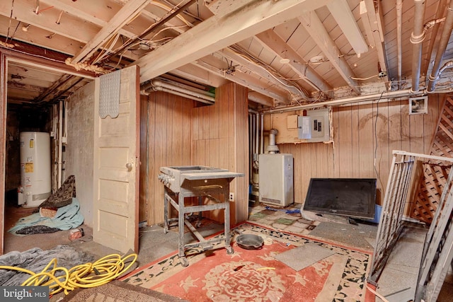 unfinished below grade area featuring gas water heater, electric panel, and wood walls