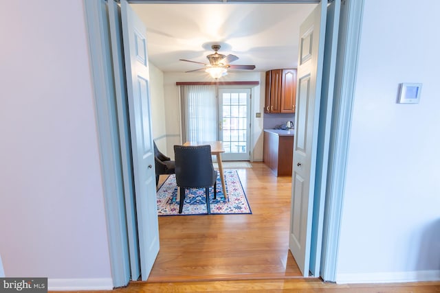 dining space featuring light wood-type flooring and ceiling fan