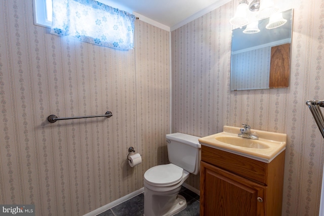 half bath with wallpapered walls, toilet, ornamental molding, tile patterned floors, and vanity