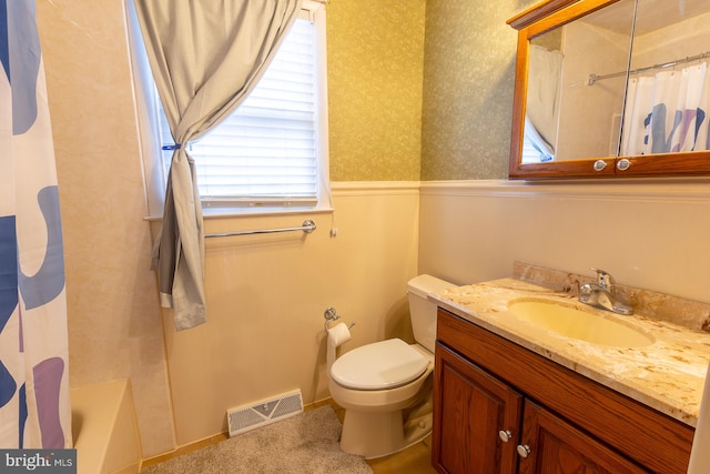 bathroom with vanity, visible vents, wallpapered walls, wainscoting, and toilet