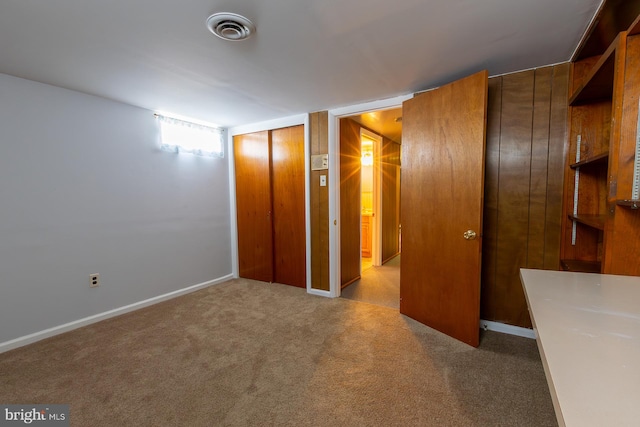 unfurnished bedroom with a closet, visible vents, baseboards, and carpet floors