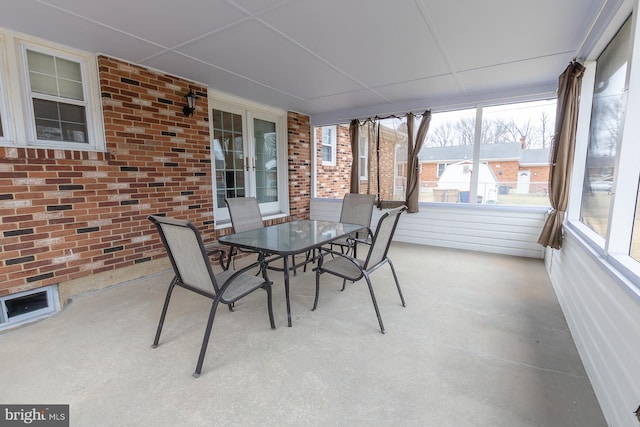 unfurnished sunroom featuring french doors and a drop ceiling