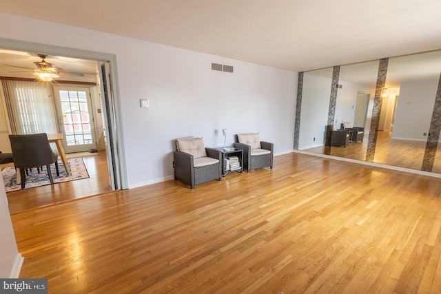 unfurnished room featuring visible vents, baseboards, a ceiling fan, and light wood finished floors