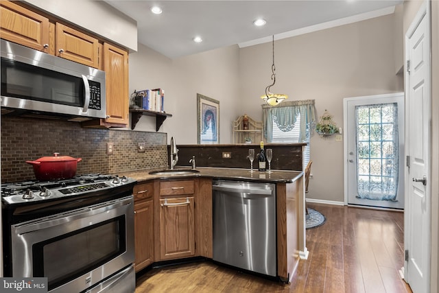 kitchen with backsplash, appliances with stainless steel finishes, and a sink