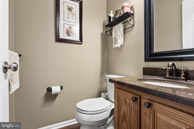 half bathroom featuring toilet and vanity