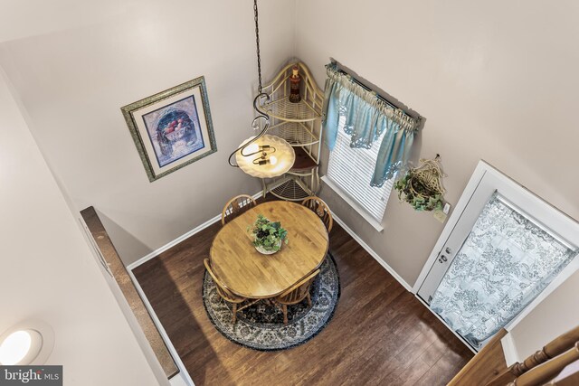 interior space with wood finished floors and baseboards