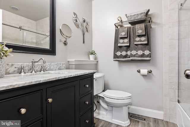 full bath featuring visible vents, toilet, wood finished floors, baseboards, and vanity