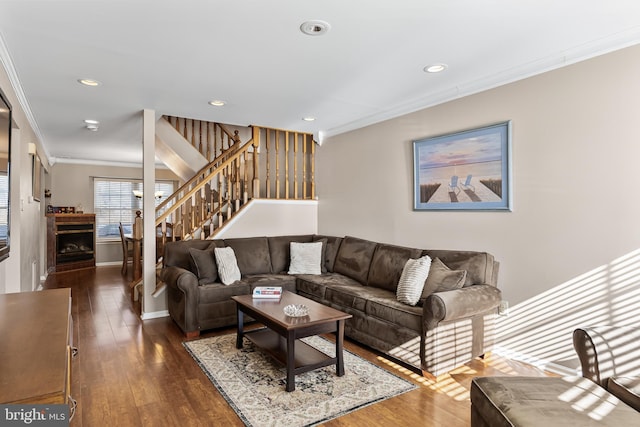 living room featuring baseboards, recessed lighting, dark wood-style flooring, ornamental molding, and stairs