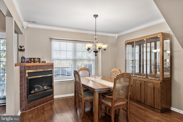 dining area with a wealth of natural light, visible vents, wood finished floors, and a chandelier