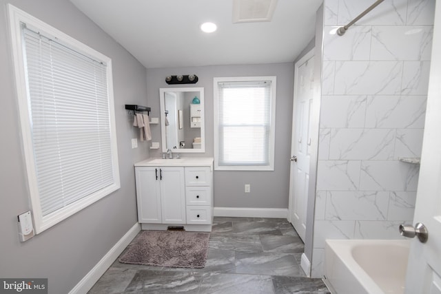 full bath with visible vents, marble finish floor, shower / bath combination, baseboards, and vanity