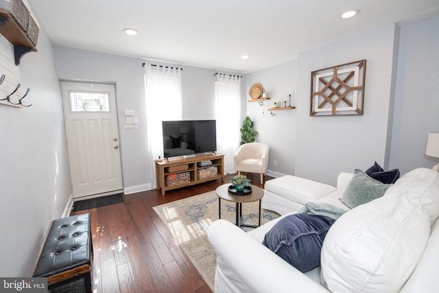 living room with recessed lighting, baseboards, and dark wood-style flooring