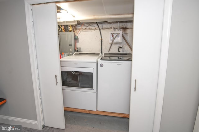 clothes washing area featuring electric panel, laundry area, and washer and dryer