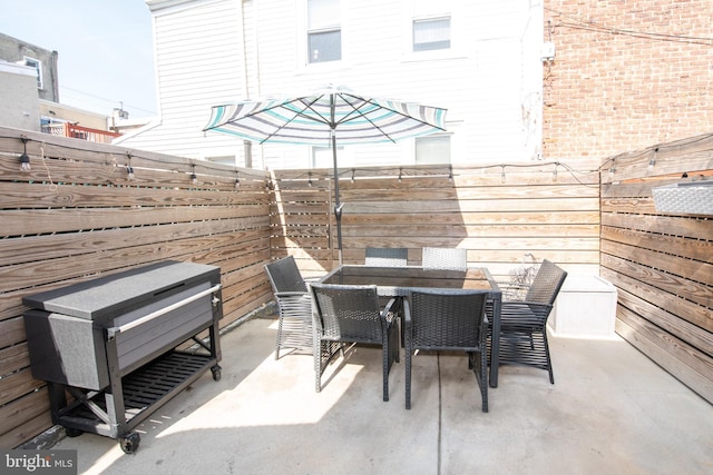 view of patio with a fenced backyard and outdoor dining space