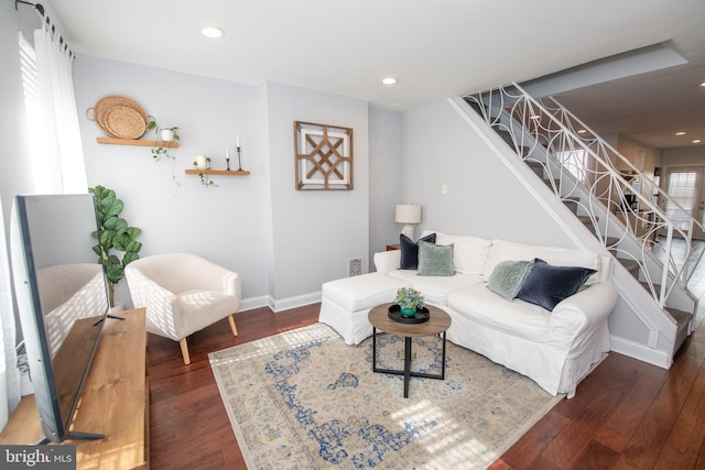 living room with recessed lighting, stairway, baseboards, and wood finished floors