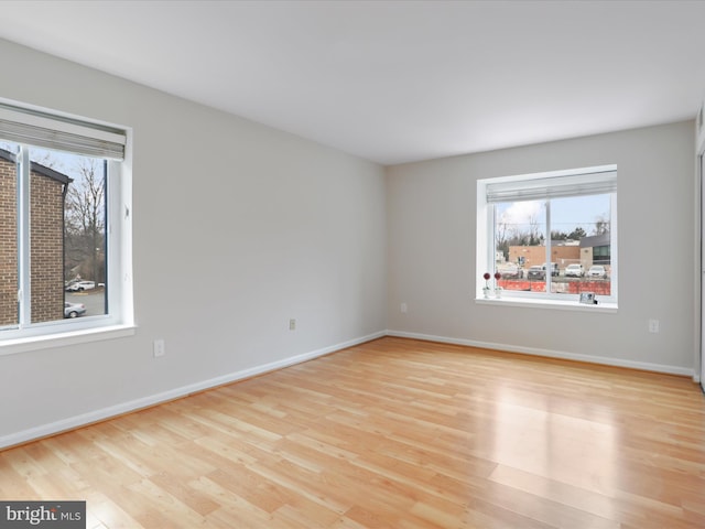 unfurnished room with wood finished floors and baseboards