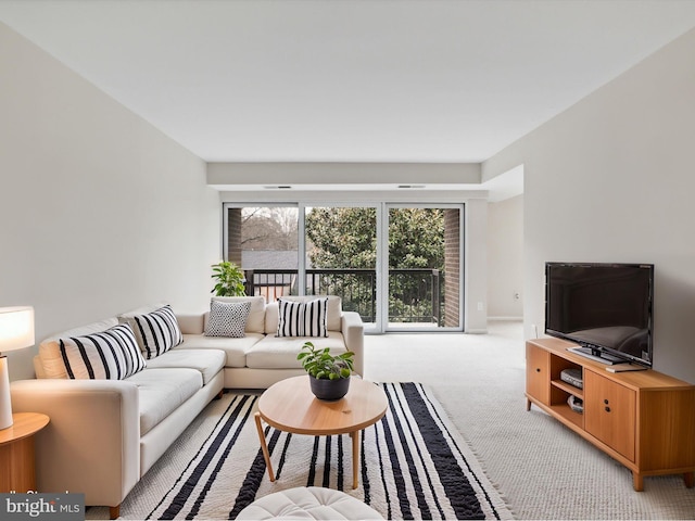 living area with light colored carpet