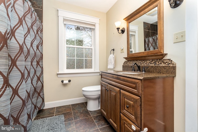 full bathroom with vanity, toilet, tasteful backsplash, and baseboards