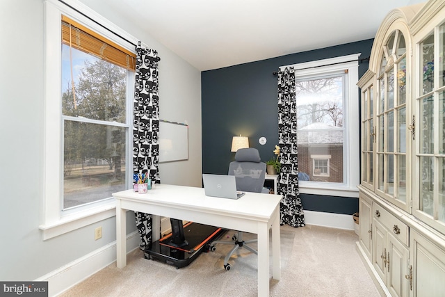 carpeted office space with plenty of natural light and baseboards