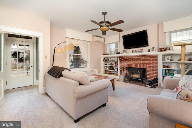 living room with a ceiling fan, an AC wall unit, and carpet flooring