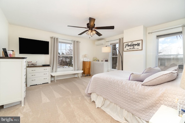 bedroom featuring light carpet, multiple windows, a ceiling fan, and a wall mounted AC