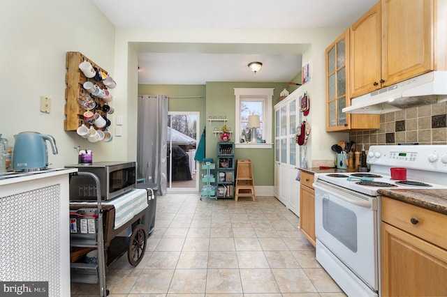 kitchen with tasteful backsplash, stainless steel microwave, glass insert cabinets, under cabinet range hood, and white electric range