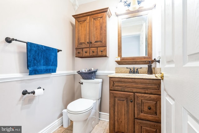 bathroom featuring baseboards, toilet, vanity, and tile patterned flooring