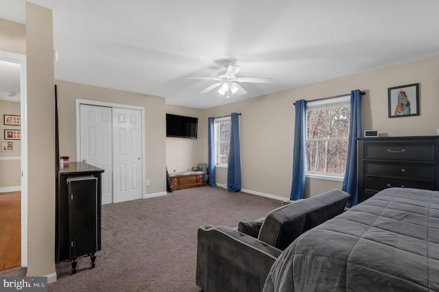 bedroom featuring a closet, baseboards, carpet, and ceiling fan