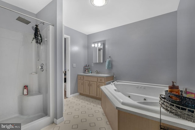 full bath featuring vanity, a shower stall, a jetted tub, and baseboards