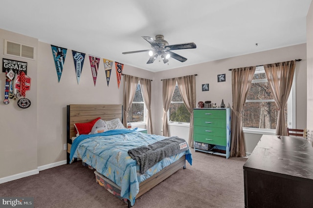 carpeted bedroom with visible vents, a ceiling fan, and baseboards