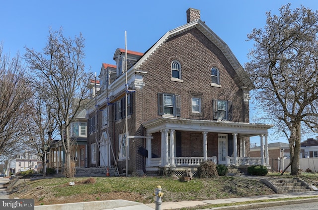 228 Cumberland St, Lebanon, PA 17042 - view of front of house featuring brick siding, a porch, and a chimney