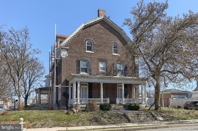 228 Cumberland St, Lebanon, PA 17042 - view of front of house with covered porch, brick siding, and a chimney