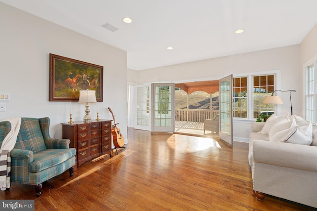 sitting room featuring recessed lighting, visible vents, baseboards, and wood finished floors