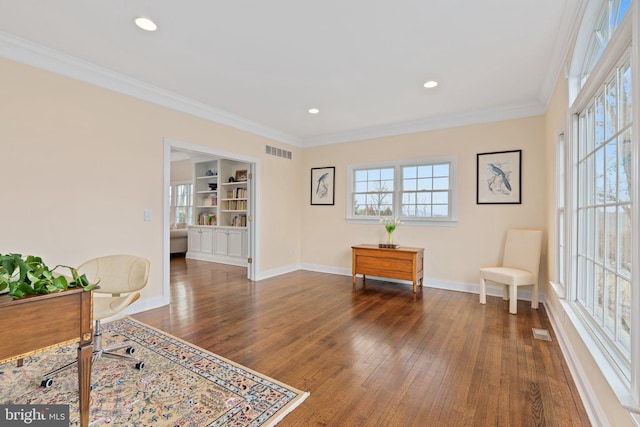 living area featuring visible vents, plenty of natural light, dark wood-type flooring, and ornamental molding